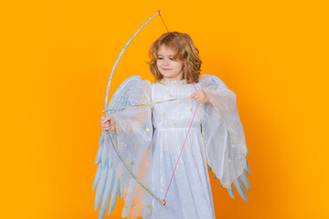 Angel child cupid with bow and arrow. Beautiful little angel. Isolated studio shot. Cute Pretty...