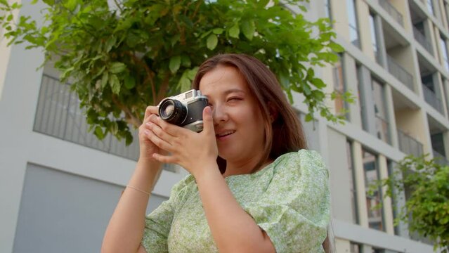 Woman travel blogger takes pictures using Russian old soviet camera Zenit, 4K slow motion