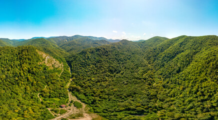 aerial panorama of a mountain stream above the forests in the mountains of the Western Caucasus on a sunny summer day © Alexei Merinov