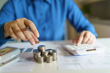 Business woman calculating financial statement on calculator&nbsp;income tax online return&nbsp;and payment.