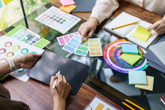 Teamwork brainstorming Creative idea Business project. Business People meeting taking notes while discussing with Color swatch samples to share idea