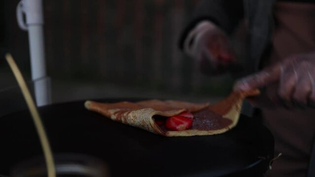 French Chef Preparing Delicious Nutella Strawberry Crepe in Paris, Close-up