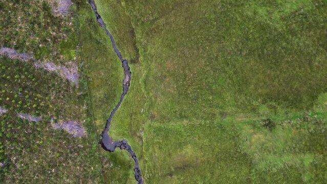 Drone shot looking down on a creek  and farmland near Glenniff Horseshoe.