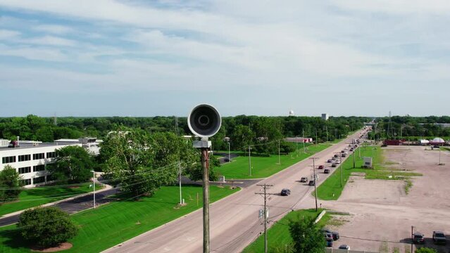 orbiting aerial Emergency natural disaster Siren. Seek shelter when activated. Horn pole for population of the city about emergency situations. Plainfield Illinois USA - Drone Aerial 4k
