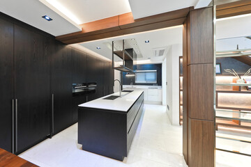 A modern kitchen interior design was created by placing the sink in the center