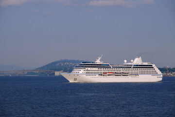 Luxury cruiseship cruise ship liner Regatta sail away departure from Vancouver, British Columbia to Alaska with beautiful nature landscape coast scenery bridge travel adventure