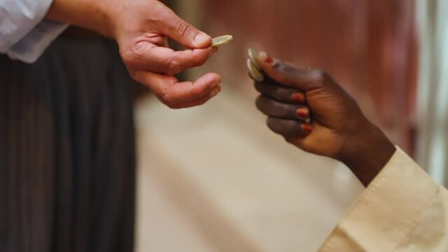 Hands Of Two Persons Exchanging Algerian Dinar Coins At The Market In Ghardaia, Algeria. closeup