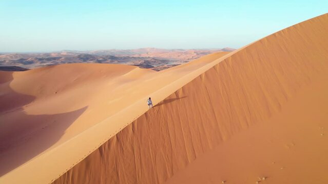 Man In The Sand Dunes Of The Algerian Sahara Desert, Djanet, Algeria - aerial drone shot