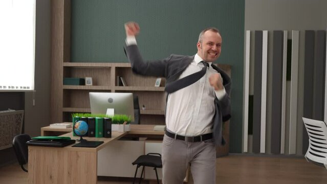 Successful cheerful happy Caucasian Businessman in the office celebrating his win. White male employee celebrating success after winning his Business case. 4K High-quality slow motion footage