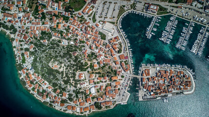 Old city at the sea coast. Croatia Tribunj. Aerial drone view.