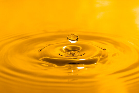 yellow drop oil , Liquid gold oil drop ripple background.