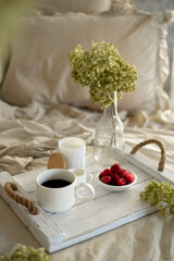 Still life with a cup of coffee with milk, flowers and cakes