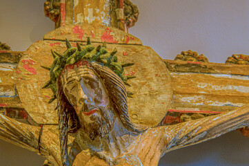 Jesus crucified, a wooden sculpture in bright colours