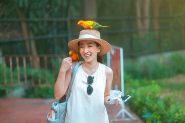 cute girl in dress and hat with activity feed food bird