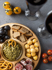 Wooden menagerie with beer snacks. A plate with assorted sausages, cheese, crackers.