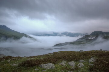 Fototapeta na wymiar Evening fog spreads over the mountain valley. Evening shooting at dusk. Soft focus.