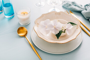 Spring shabby chic table setting, plate decorated with flowers