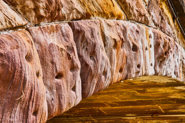 Gold hue on underside of stone bridge with gorgeous textured arch abstract background asset
