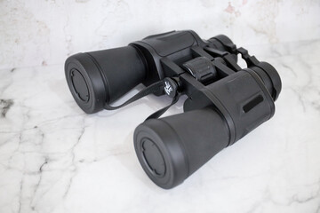 Binoculars on an isolated white background. Zoom binocular for astronomy observation or military 