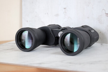 Binoculars on an isolated white background. Zoom binocular for astronomy observation or military 