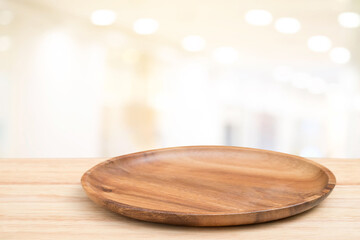Empty wooden tray on perspective wooden table on top over blur background. Can be used mock up for...
