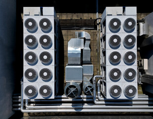 The cooling units are industrial or air-conditioning, which are used in the summer for cooling the premises, with fans on the roof of the storage hall, mainly for industrial operations, high angle