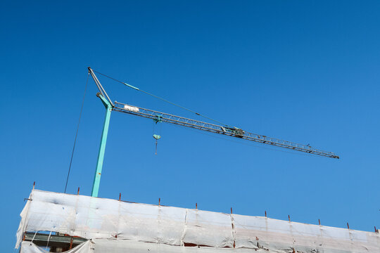 Hoist crane building construction houses roof transport construction material sky