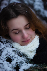 A woman in winter on the street in a hat