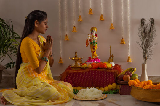 Woman praying to Lord Krishna on the occasion of Janmashtami