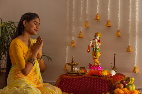 Woman praying to Lord Krishna on the occasion of Janmashtami