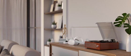 A vintage vinyl record player on a wooden shelf in a cozy Scandinavian living room. © bongkarn