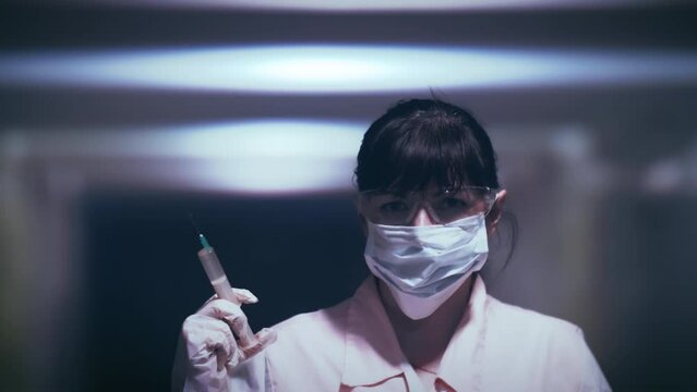 Woman with Syringe in Dimly Lit Medical Room Advances towards Camera with Sinister Intentions