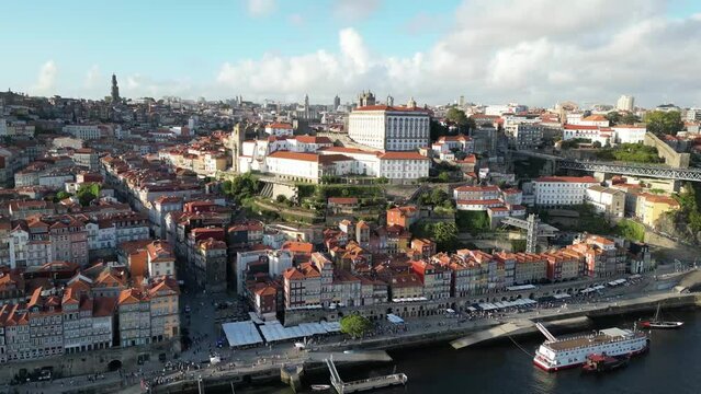 Drone shot flying up with river in view in Porto Portugal at sunset.
