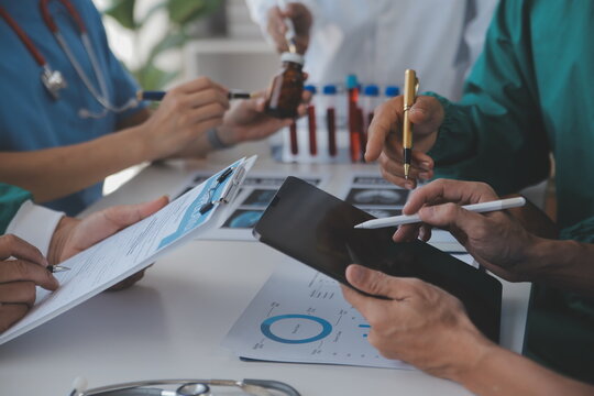 Medical technology network team meeting concept. Doctor hand working smart phone modern digital tablet laptop computer graphics chart interface, sun beams effect photo