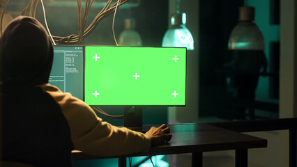 Male spy using computer display with greenscreen while stealing government information, planning...