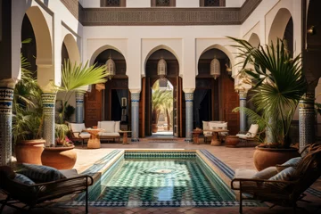 Fototapete Marokko Moroccan riad , reflecting the distinctive architecture of North Africa. Courtyard house with a central fountain, surrounded by arched doorways