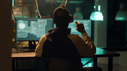 African american hacker using virtual reality glasses to hack computer server, creating malware and...
