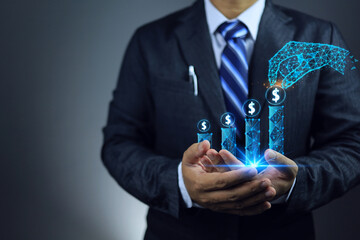 Businessman holding a revenue graph in his hand and future trend increase and polygon or smart hand...