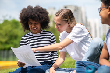 Blonde girl helping kids with home work