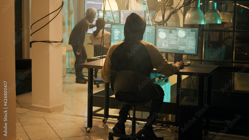 Poster silhouette of hacker coding encryption to plant trojan virus, looking to steal important information