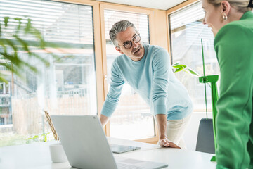 Businessman having discussion with colleague in office