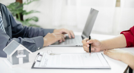 Fototapeta premium Real estate agents offer sale home insurance and close the sale immediately after the customer signs a purchase contract under a formal agreement. Real Estate Home insurance concept