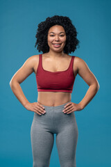 Sporty young woman in sportwear on blue background