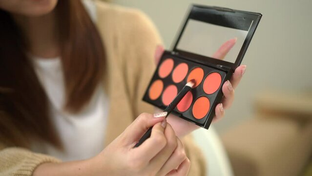 Close-up attractive young influencer woman share makeup tutorials on social media. Beauty blogger sells cosmetics shopping online. Makeup artist vlogger teaching on social media.
