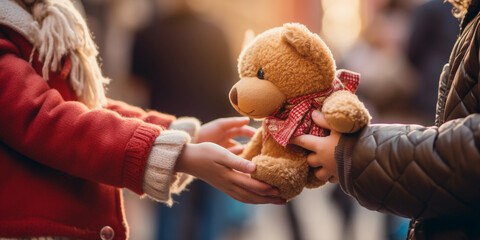 Poignant image of a child's hand receiving a teddy bear at a charity event, shallow depth of field, vibrant colors - obrazy, fototapety, plakaty