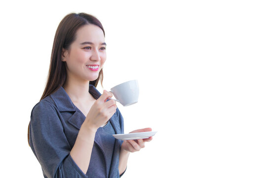 Professional Young Asian Confident Working Woman Is Looking Out Of Window To Think Something While Holds Coffee Cup In Her Hand While Isolated On White Background.