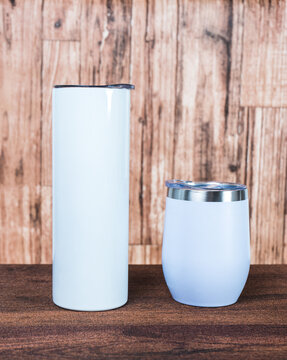 Embrace the timeless allure of a white blank tumbler in this captivating mockup image, arranged with contemporary finesse