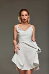 Studio portrait of a young girl with disability wearing sensory bionic prosthetic arm. Beautiful...