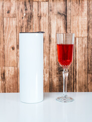 A captivating mockup image beautifully presents a white blank tumbler, artfully arranged with a touch of wine-themed allure