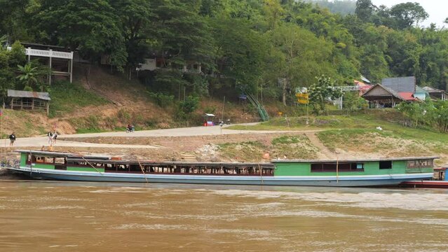  Slow Wooden Tourist Boats on Mekong River at Pak Beng Village, High Quality 4K Slowmotion Tourism and Travel in South East Asia Concept Footage. Laos.